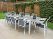 Outdoor dining set with a table and chairs on a patio area.